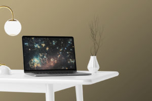 Free MacBook Pro on white Table Mockup